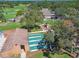 Aerial view of the playground and shuffleboard courts with landscape at 12101 Meadowbrook Ln, Hudson, FL 34667