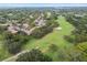 Scenic aerial view of lush community, showcasing golf course views and mature tree coverage at 12101 Meadowbrook Ln, Hudson, FL 34667