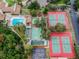 Aerial view of the community pool, tennis courts, basketball court, bocce ball and shuffleboard courts at 12101 Meadowbrook Ln, Hudson, FL 34667