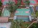 Aerial view of the basketball court and shuffleboard courts with landscape at 12101 Meadowbrook Ln, Hudson, FL 34667
