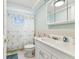 Bathroom with a white vanity and a shower with tub at 12101 Meadowbrook Ln, Hudson, FL 34667