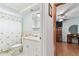 Bathroom with a white vanity, a shower with tub, and seashell themed shower curtain at 12101 Meadowbrook Ln, Hudson, FL 34667