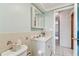 Bathroom featuring a modern vanity, tiled backsplash, and a tiled floor at 12101 Meadowbrook Ln, Hudson, FL 34667