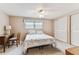 Comfortable bedroom featuring a ceiling fan, a window with a valance, and a built-in desk at 12101 Meadowbrook Ln, Hudson, FL 34667