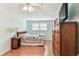 Bedroom featuring wood floors, a fan and a nice side table at 12101 Meadowbrook Ln, Hudson, FL 34667