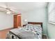 Bedroom with wood floors, closet, and a view to the outside at 12101 Meadowbrook Ln, Hudson, FL 34667