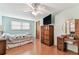 Well-lit bedroom with wood floors, and traditional furniture at 12101 Meadowbrook Ln, Hudson, FL 34667