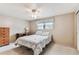 Bright bedroom featuring a ceiling fan and a window with decorative valance at 12101 Meadowbrook Ln, Hudson, FL 34667
