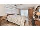 Cozy bedroom with a full bed, wooden furnishings, and sliding glass door to the outside at 12101 Meadowbrook Ln, Hudson, FL 34667