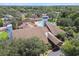 Scenic aerial view of the clubhouse, showcasing mature trees and manicured landscapes at 12101 Meadowbrook Ln, Hudson, FL 34667
