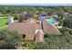 Scenic view of the clubhouse offering amenities with mature trees and manicured landscapes at 12101 Meadowbrook Ln, Hudson, FL 34667