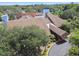 Picturesque aerial view of the clubhouse with mature trees and well manicured landscaping at 12101 Meadowbrook Ln, Hudson, FL 34667
