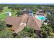Aerial view of the community clubhouse, pool, and well-maintained landscape at 12101 Meadowbrook Ln, Hudson, FL 34667
