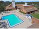 Aerial view of community pool and clubhouse with many lounge chairs and tables at 12101 Meadowbrook Ln, Hudson, FL 34667