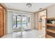 Bright dining area with tile flooring and sliding glass doors providing access to a screened pool area at 12101 Meadowbrook Ln, Hudson, FL 34667