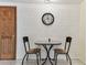 Cozy dining area features a white brick wall and seating for two at 12101 Meadowbrook Ln, Hudson, FL 34667