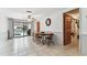 Open dining area with tile floors and sliding glass doors leading to the pool area at 12101 Meadowbrook Ln, Hudson, FL 34667