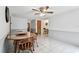 Open dining room with tile floors and access to multiple areas of the home at 12101 Meadowbrook Ln, Hudson, FL 34667