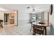 Bright dining area featuring tile flooring and a view into the adjacent kitchen at 12101 Meadowbrook Ln, Hudson, FL 34667