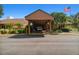 Exterior of the community center with an awning covered entrance and American flag at 12101 Meadowbrook Ln, Hudson, FL 34667
