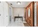 Bright foyer with tile flooring, a wooden front door with glass, and a classic console table at 12101 Meadowbrook Ln, Hudson, FL 34667
