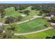 Picturesque aerial view of the golf course with water features and mature trees at 12101 Meadowbrook Ln, Hudson, FL 34667