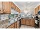 Charming kitchen features tile floors, granite counters and wood cabinetry at 12101 Meadowbrook Ln, Hudson, FL 34667