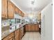 Charming kitchen features tile floors, granite counters and stainless appliances at 12101 Meadowbrook Ln, Hudson, FL 34667