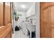 Functional laundry room with tile flooring, storage cabinets, and sink at 12101 Meadowbrook Ln, Hudson, FL 34667