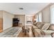 Inviting living room featuring hardwood floors, neutral paint, comfortable couches, and a decorative rug at 12101 Meadowbrook Ln, Hudson, FL 34667