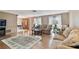 Spacious living room with hardwood floors, neutral paint, comfortable couches, and a decorative rug at 12101 Meadowbrook Ln, Hudson, FL 34667