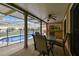 Covered patio offering a shaded area with a table and chairs, plus views of the sparkling pool at 12101 Meadowbrook Ln, Hudson, FL 34667