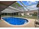 Sparkling pool with screened enclosure, perfect for recreation and relaxation in a private setting at 12101 Meadowbrook Ln, Hudson, FL 34667