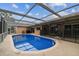 Inviting screened pool surrounded by a spacious patio, great for outdoor entertaining and leisure at 12101 Meadowbrook Ln, Hudson, FL 34667