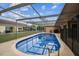 Beautiful pool and deck area enclosed with screen, ideal for outdoor relaxation and swimming at 12101 Meadowbrook Ln, Hudson, FL 34667