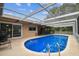 Backyard featuring a beautiful screened pool, offering a refreshing retreat and outdoor enjoyment at 12101 Meadowbrook Ln, Hudson, FL 34667