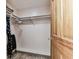 Spacious walk-in closet features built-in shelving and modern flooring at 12101 Meadowbrook Ln, Hudson, FL 34667
