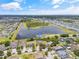 An aerial view showcases the home's location near a tranquil lake, set within a vibrant community of residences at 12244 Fairlawn Dr, Riverview, FL 33579