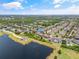 Aerial view captures the property's positioning next to a serene lake, complete with well-maintained community grounds at 12244 Fairlawn Dr, Riverview, FL 33579