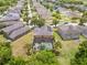 Aerial view of a home featuring solar panels and screened-in pool amidst lush landscaping at 12244 Fairlawn Dr, Riverview, FL 33579