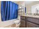 Well-lit bathroom featuring vanity with dark cabinets and solid surface counters at 12244 Fairlawn Dr, Riverview, FL 33579