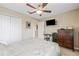 Cozy bedroom offering neutral tones, ceiling fan, and mounted TV at 12244 Fairlawn Dr, Riverview, FL 33579
