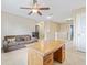 Loft area with desk, sofa, ceiling fan and access to multiple doors at 12244 Fairlawn Dr, Riverview, FL 33579