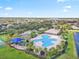 Aerial view of the community pool area, with its winding pool, playground, and nearby amenities at 12244 Fairlawn Dr, Riverview, FL 33579