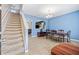 Inviting dining room featuring a staircase, modern chandelier, stylish furniture, and neutral tile flooring at 12244 Fairlawn Dr, Riverview, FL 33579