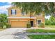Charming two-story home with a two-car garage, manicured landscaping, and a welcoming front entrance at 12244 Fairlawn Dr, Riverview, FL 33579