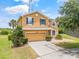 Attractive two-story home featuring a two-car garage, and a well-manicured front yard at 12244 Fairlawn Dr, Riverview, FL 33579