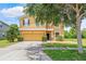 Two-story home featuring a two-car garage, inviting entrance, and well-maintained landscaping at 12244 Fairlawn Dr, Riverview, FL 33579