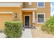 Home exterior featuring a tidy landscaped yard, a dark-colored front door, and stone porch supports at 12244 Fairlawn Dr, Riverview, FL 33579