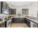 Modern kitchen features granite countertops and stainless steel appliances at 12244 Fairlawn Dr, Riverview, FL 33579